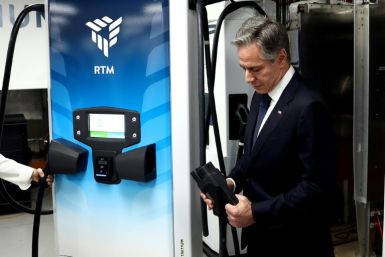 US Secretary of State Antony Blinken holds a charger during a tour of Brisbane electric vehicle (EV) company Tritium