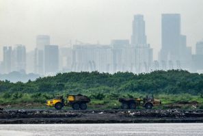 Trucks transport ash from incinerated garbage on Pulau Semakau island, which serves as Singapore's offshore landfill