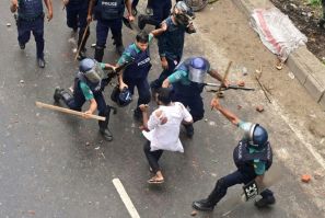 Bangladesh police fired rubber bullets and tear gas to disperse stone-throwing crowds blockading major roads in the capital Dhaka