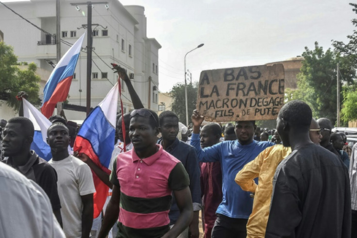 Coup supporters on Sunday held up Russian flags and a placard reading 'Down with France, Macron get out'