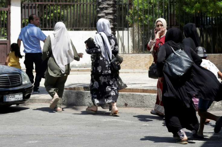 Residents leave Ain al-Helweh, Lebanon's largest Palestinian refugee camp, during clashes over the weekend