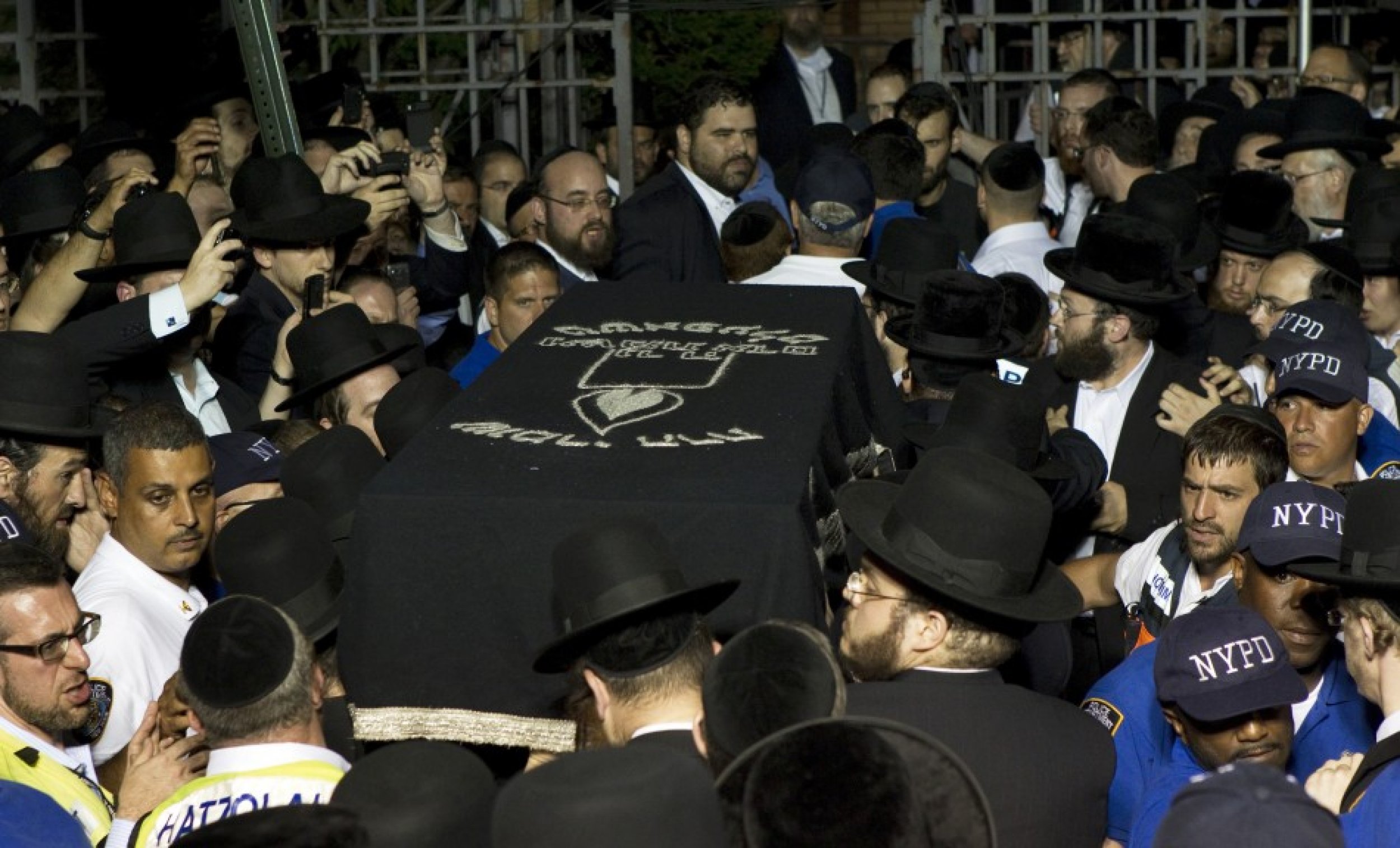 The casket of Leiby Kletzky is carried into a synagogue for his funeral service in New York