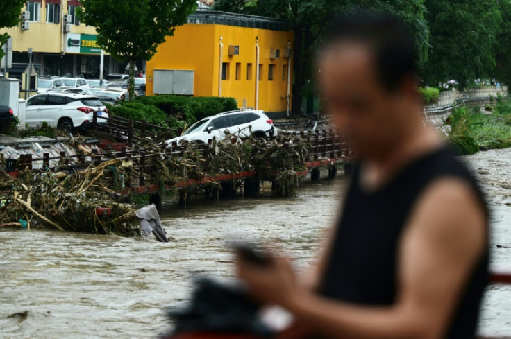 At least two people died from floods in Beijing on Monday, while another two casualties were reported in northeastern Liaoning over the weekend