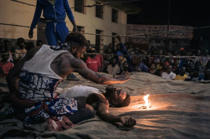 Gone for a spell: A voodoo wrestler floors his opponent