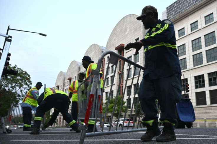 Workers set up barricades before the arrival of former US president Donald Trump for arraignment at the E. Barrett Prettyman US States Courthouse in Washington, DC on August 3, 2023