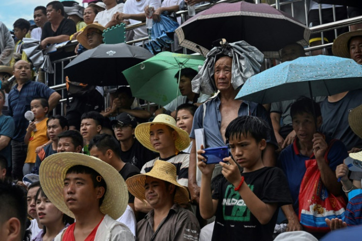 Fans brave the rain during the grassroots basketball competition in Taipan village in southwestern China's Guizhou province
