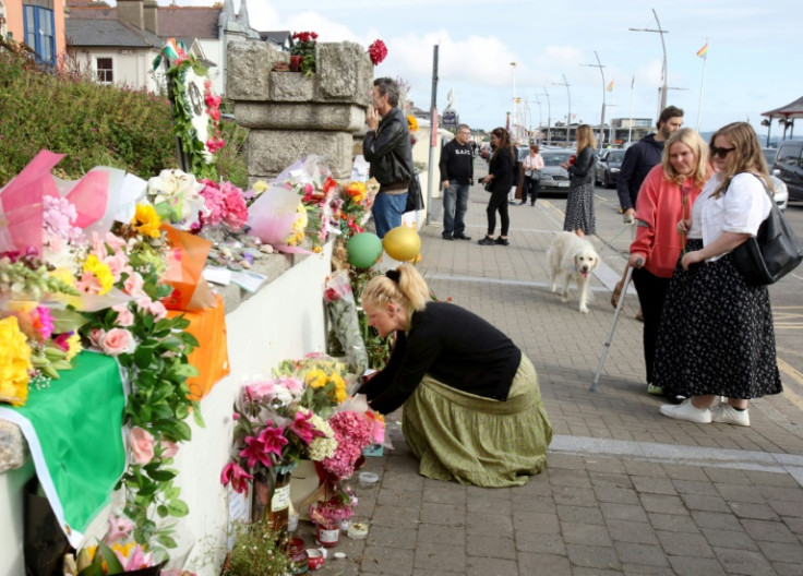 People lay flowers and tributes outside the former home of Irish singer Sinead O'Connor, in Bray, eastern Ireland, ahead of her funeral