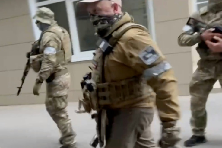 A video grab taken from footage posted on Telgram shows Wagner chief Yevgeny Prigozhin (center) walking in the city of Rostov-on-Don