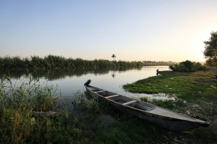 A fishing boat is moored along a branch of the Euphrates River in Al-Hamza town near Hilla in central Iraq, where river water levels have fallen