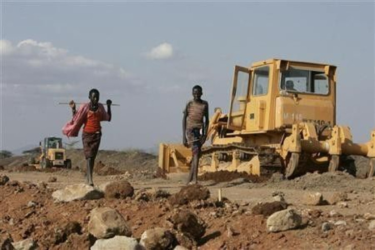 Turkana boys walk past a road construction project near Isiolo town