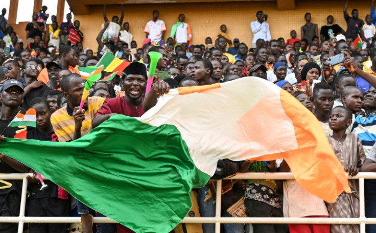 Coup supporters cheer during a concert at the General Seyni Kountche Stadium in Niamey on August 13, 2023