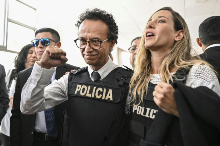 Journalist and presidential candidate for the Construye party, Christian Zurita (C), gestures next to his running mate, vice presidential candidate Andrea Gonzalez (R), in Quito on August 13, 2023