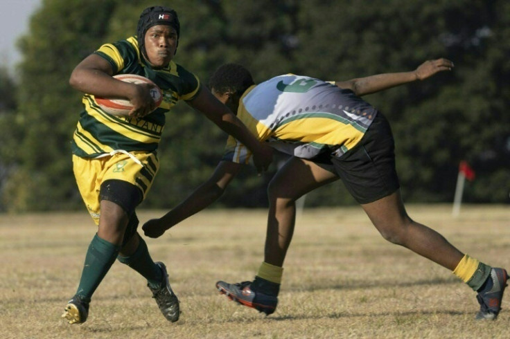 Sonwabo Buso (L) from Soweto's Jabulani Technical Secondary School Under-16 rugby team in action against Vryburger high school in Johannesburg on June 21, 2023