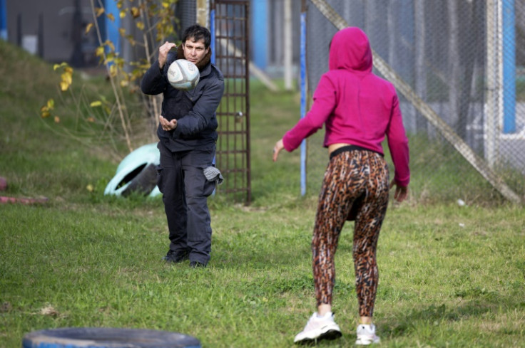 A prison officer passes the ball to an inmate at one of Montevideo's women's jails