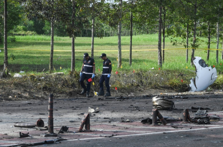 A light plane crashed west of the Malaysian capital, killing eight people on board and two motorists on the ground, officials say
