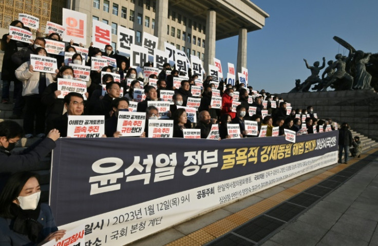South Korean opposition lawmakers and supporters of the victims of Japan's wartime forced labor hold placards protesting reconciliation with Tokyo by President Yoon Seok-yeol in January 2023