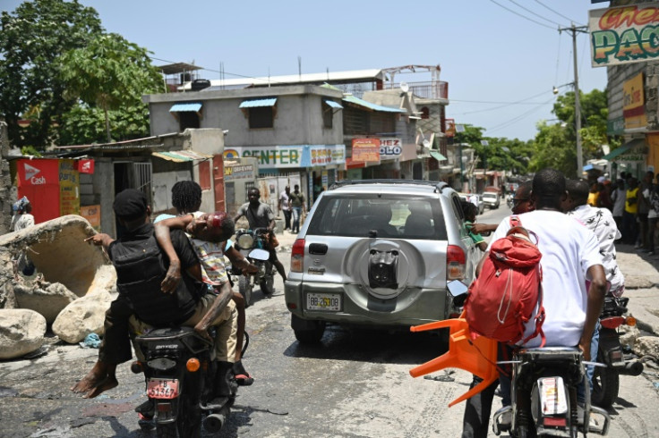 An injured man is transported on a motorcycle to hospital after being shot during gang violence in Port-au-Prince, Haiti, in August 2023
