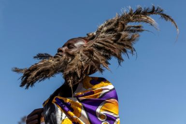 The young Maasai men wear ceremonial headdresses of ostrich feathers