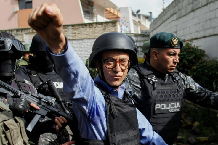 Ecuadoran presidential candidate Christian Zurita gestures as he leaves under heavy security after voting at a polling station in Quito