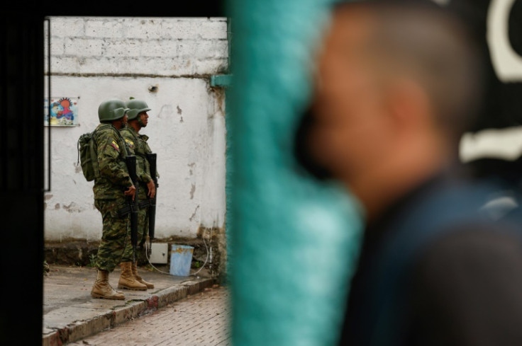 Soldiers stand guard at a polling station in Quito
