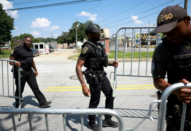 Officers put up fencing near an entrance to the Fulton County Jail in Atlanta, Georgia