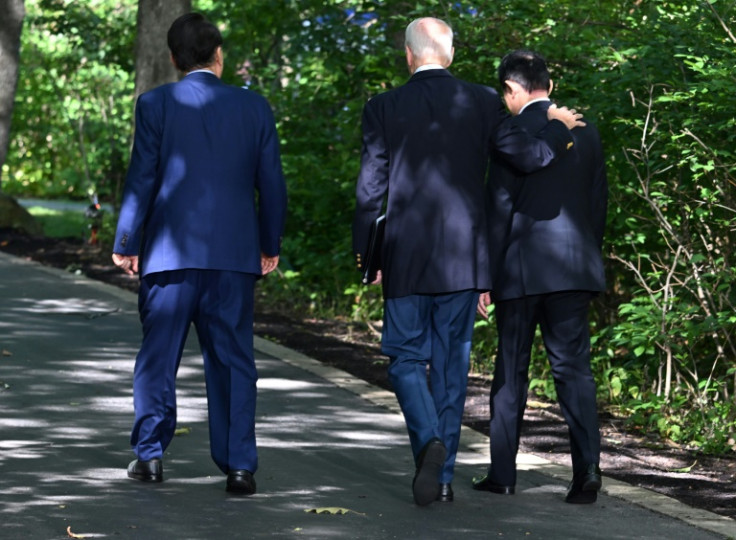 US President Joe Biden (center), Japanese Prime Minister Fumio Kishida (right) and South Korean President Yoon Suk Yeol leave after a press conference at Camp David on August 18, 2023