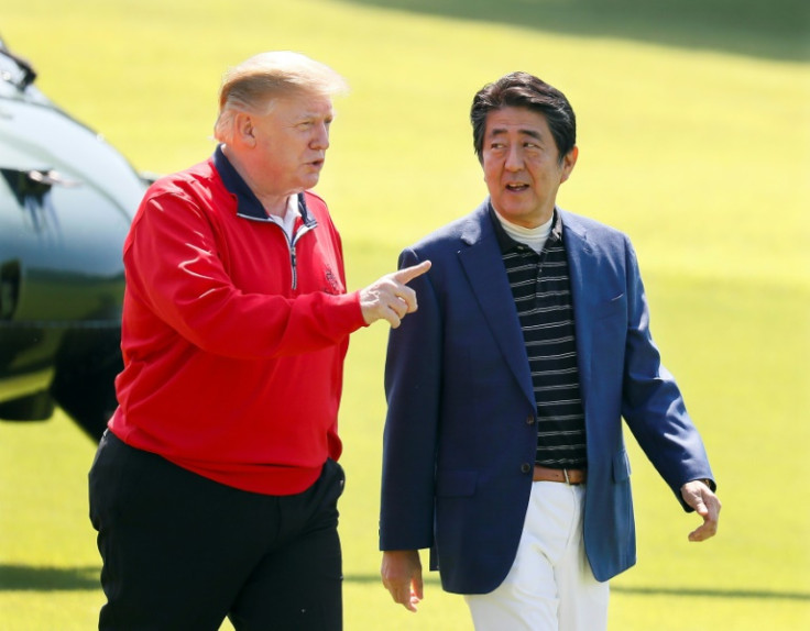 Japan's then prime minister Shinzo Abe listens to then US president Donald Trump before they play golf in Chiba, Japan on May 26, 2019