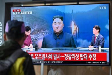 A man watches a television screen showing a news broadcast with file footage of North Korea's leader Kim Jong Un, at the Seoul Railway Station in Seoul in May 2023.