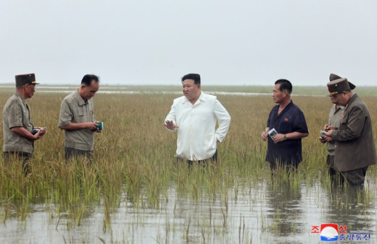 North Korean leader Kim Jong Un (C) said the recent flood damage was a disaster caused by irresponsible 'loafers'