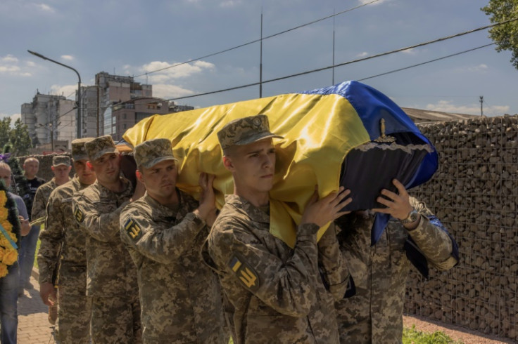 Ukrainian servicemen carry the coffin of Andrii Veremiienko, who was killed fighting Russian troops in the Donetsk region, during a funeral ceremony in Kyiv