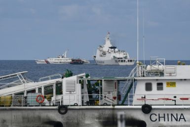 Chinese coast guard ships corrall a boat chartered by the Philippine navy for a resupply mission in the disputed South China Sea