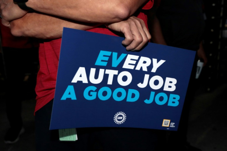 United Auto Workers members hold signs outside the Stellantis auto plant in Sterling Heights, Michigan, on July 12, 2023