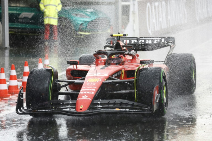 Wet, wet, wet: Ferrari's Carlos Sainz drives in the pit lane