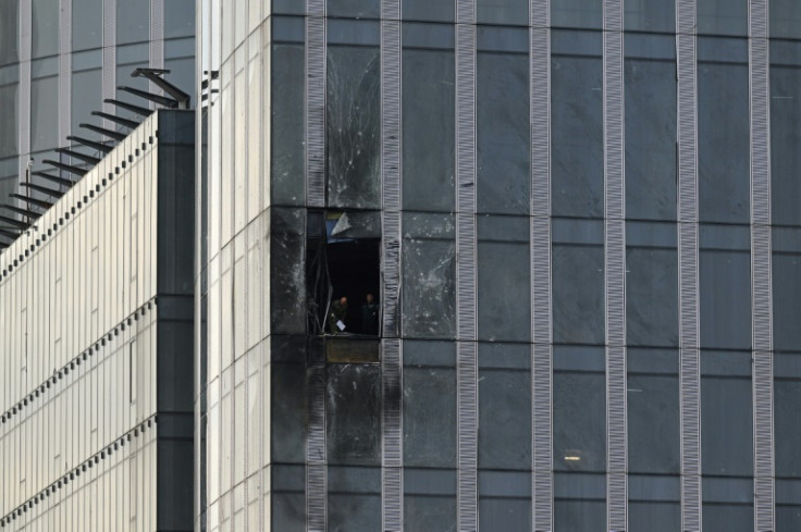 People inspect the damage sustained to a building of the Moscow International Business Center