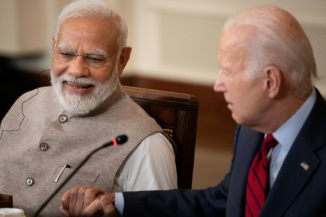 India's Prime Minister Narendra Modi and US President Joe Biden embrace hands during a meeting at the White House on June 23, 2023
