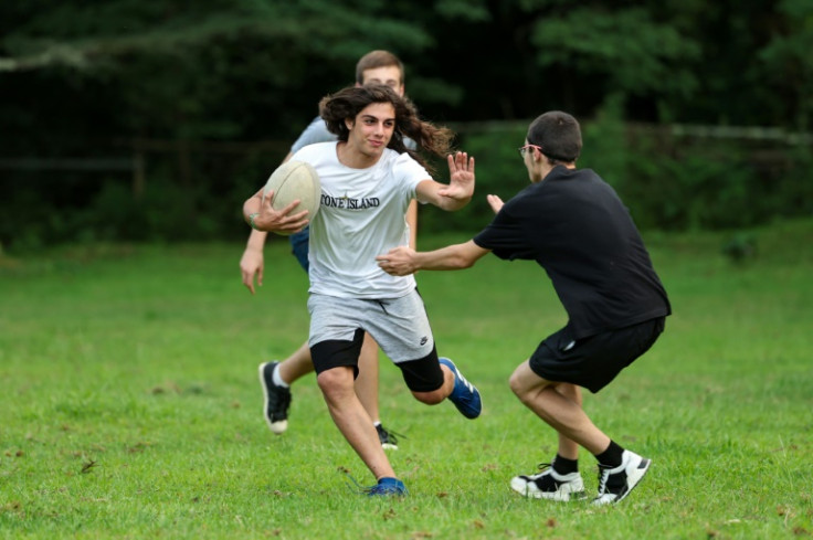 The youngsters in Shukhuti play rugby outside the village