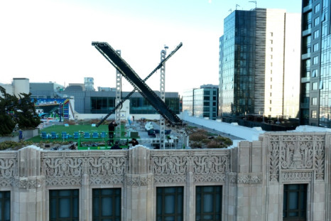 Workers install a large X on the roof of the former Twitter headquarters on July 28, 2023 in San Francisco