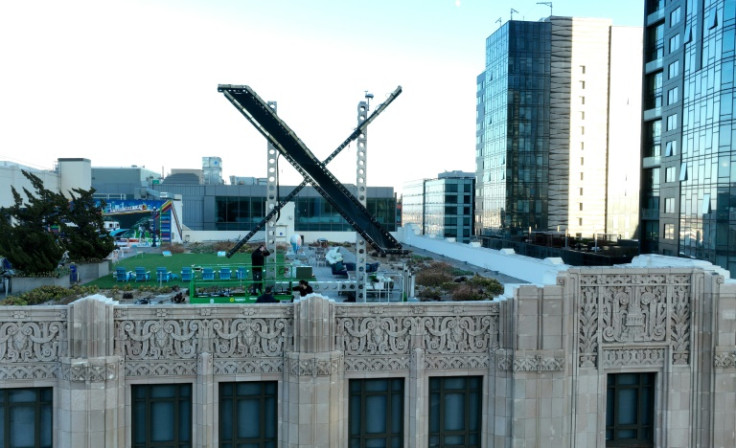 Workers install a large X on the roof of the former Twitter headquarters on July 28, 2023 in San Francisco