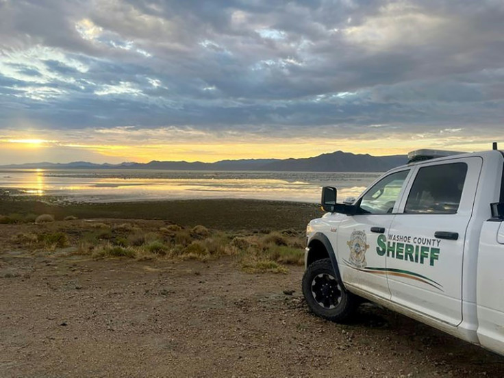 This handout received from the Washoe County Sheriff's Office on September 3, 2023 shows flooding on a desert plain seen past a Washoe County Sheriff truck, after heavy rains September 2 turned the annual Burning Man festival site in Nevada’s Black Rock d