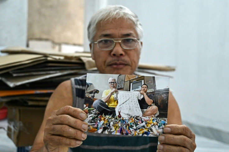 Vietnam's Nguyen Truong Chinh, whose son Nguyen Van Chuong is on death row, shows a picture of him and his other son with paper cranes received from Chuong