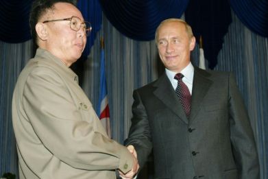 This file image shows Russian President Vladimir Putin (R) shaking hands with then-North Korean leader Kim Jong Il (L) during their meeting in Vladivostok, 23 August 2002
