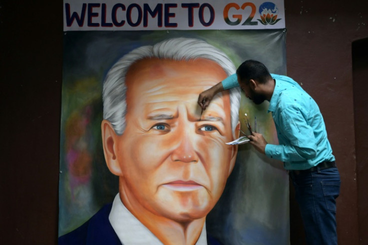 Indian artist Jagjot Singh Rubal gives final touches to an oil painting of US President Joe Biden ahead of the two-day G20 summit in New Delhi