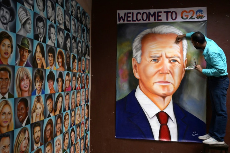 Indian artist Jagjot Singh Rubal gives final touches to an oil painting of US President Joe Biden, at his workshop in Amritsar, ahead of the G20 summit in New Delhi