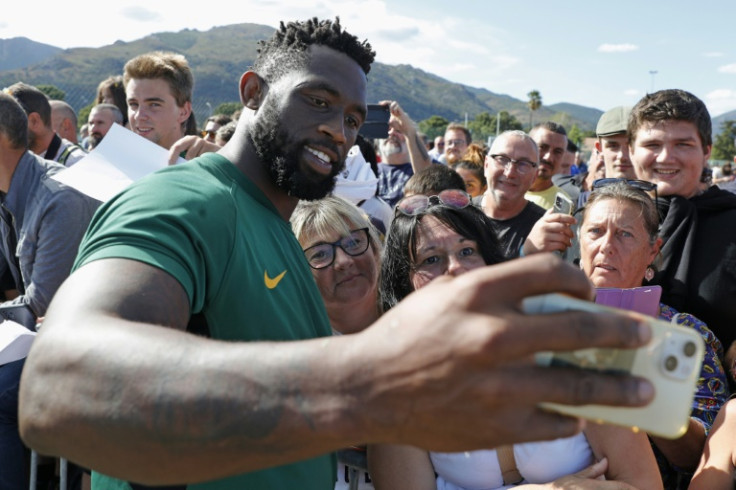 South Africa captain Siya Kolisi takes a selfie with fans as the reigning champions prepare for the defence of their title
