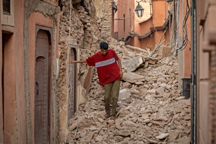 A resident of Marrakesh, Morocco watches his footing on the rubble after the country's most powerful earthquake ever