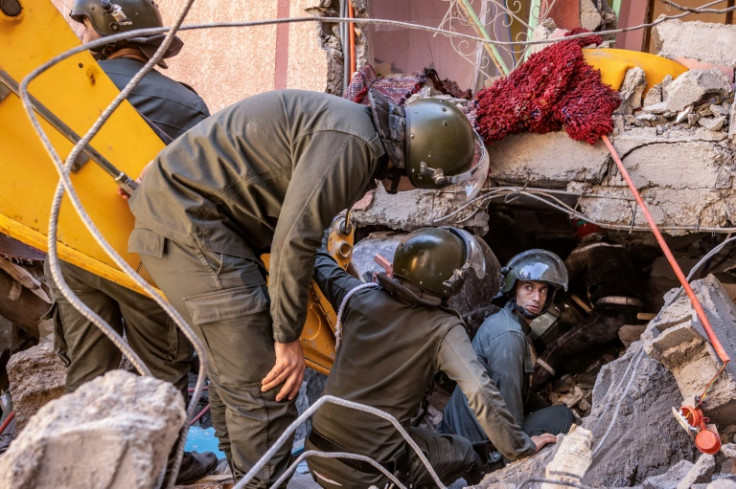 A rescue team searches for survivors under a collapsed house in the High Atlas village of Moulay Brahim, one of the hardest hit by the earthquake which struck Morocco late Friday