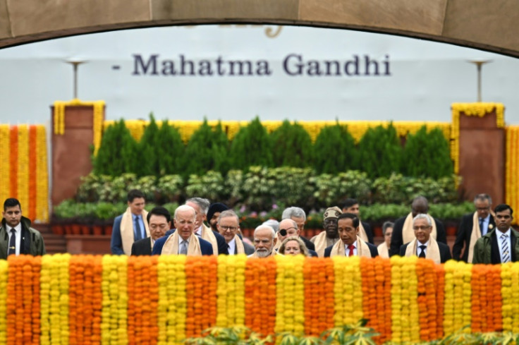 India's Prime Minister Narendra Modi (C) along with world leaders arrive to pay respect at the Mahatma Gandhi memorial in New Delhi