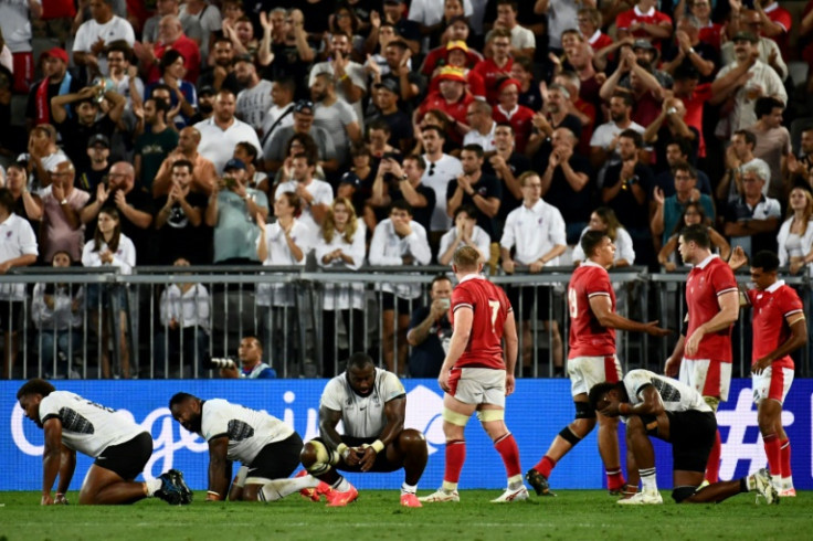 Fiji's players on their knees after the Wales loss