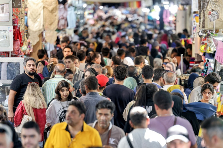 People walk at the Grand Bazaar in Tehran on September 5, 2023