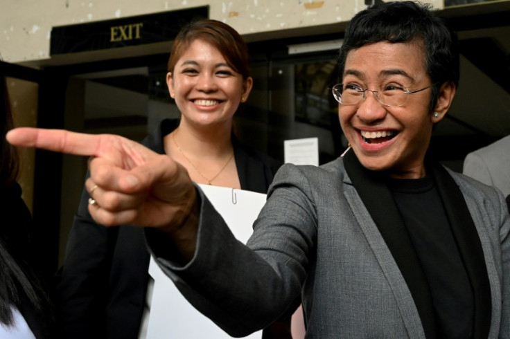 Ressa reacts outside the Pasig Regional Trial Court following her acquittal in a tax evasion case